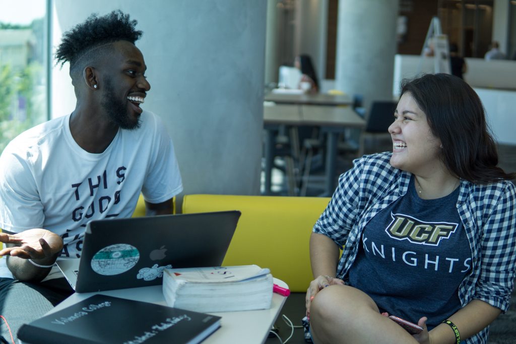 Two UCF Students Smiling in Conversation 